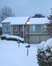 picture of house in winter snow; link for environmental article, A Few Simple Ways to Save on Your Heating Bill