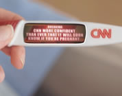 funny cable news video link; thumb of pregnancy test stick with news ticker