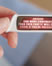 thumb of pregnancy test stick with news ticker