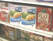natural food scam video link; thumb of boxes of natural cereal on grocery store shelves