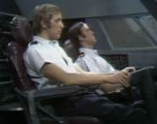 graham chapman and john cleese as airline pilots in cockpit; link for funny animation/video; opens in new window