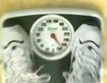 funny diet videos link; thumb of feet in athletic shoes on a scale