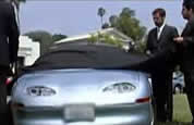 photo of people standing next to electric car; click to go to animation page; opens in new window