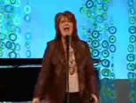photo of woman on stage singing; click to see animation/video at external site; opens in new window