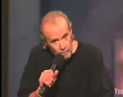 George Carlin on stage; click to go to video page at external site; opens in new window